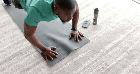 Man Exercising With Push-Ups at Home Using Yoga Mat