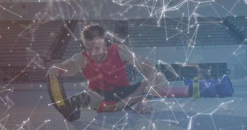 Parathlete with Running Blade Stretching at Sports Stadium