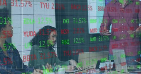 Business team meeting with woman taking notes and stock market data overlay