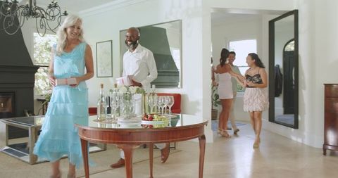 Friends Gathering for Celebration at Home with Snacks and Drinks