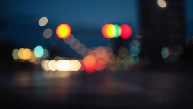 Bokeh city intersection with colorful lights at night