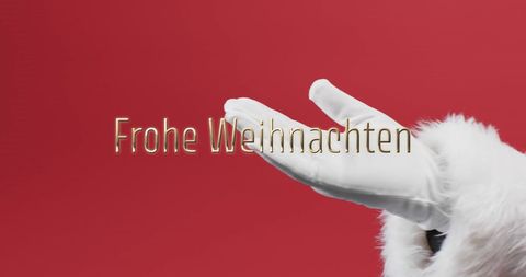 Santa hand holding frohe weihnachten text holiday greetings