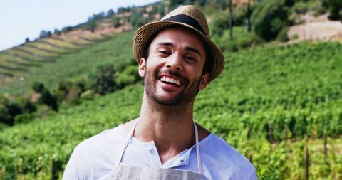 Happy Vineyard Worker Smiling in Lush Field