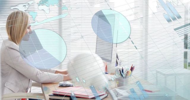 Businesswoman Analyzing Economic Data on Laptop in Modern Office