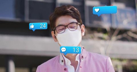 Professional man receiving social media reactions outside modern building