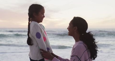 Mother and Daughter Enjoying Sunset at Beach