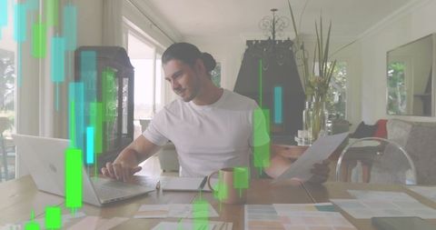 Working remotely reviewing financial reports and trading charts at modern home workspace