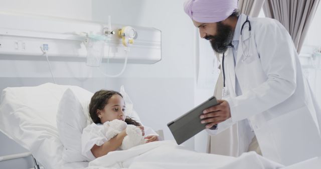 Doctor Consulting Young Patient in Hospital Room - Download Free Stock Images Pikwizard.com