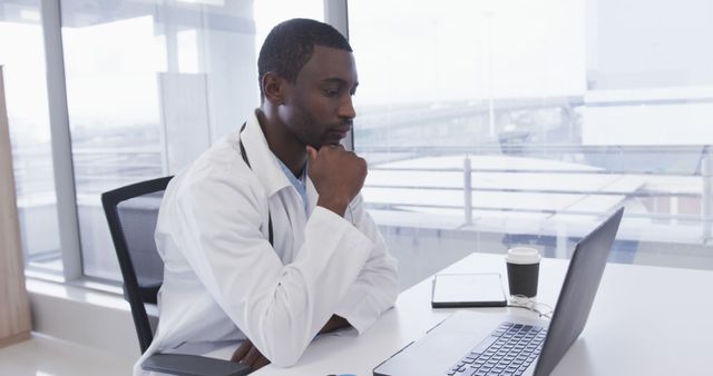 Confident Male Doctor Working on Laptop in Modern Office - Download Free Stock Images Pikwizard.com