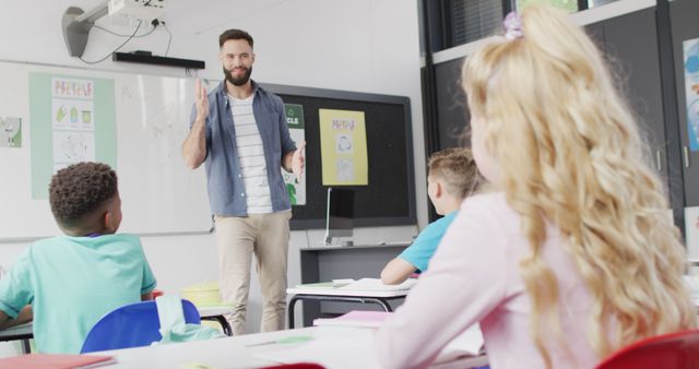 Teacher Engaging Young Students in Modern Classroom Setting - Download Free Stock Images Pikwizard.com