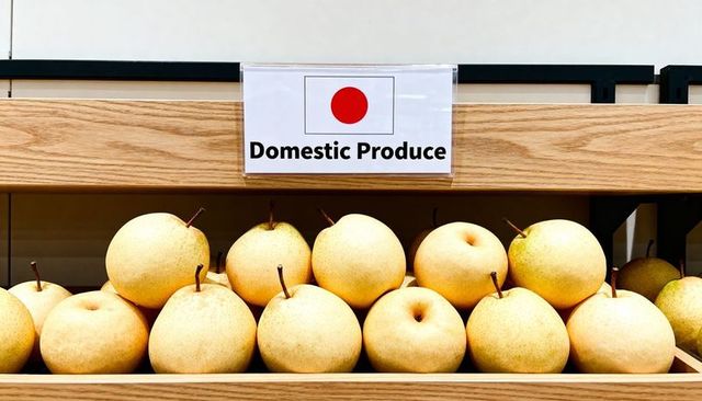 Displaying nashi asian pears on oak shelf with domestic produce sign, market display