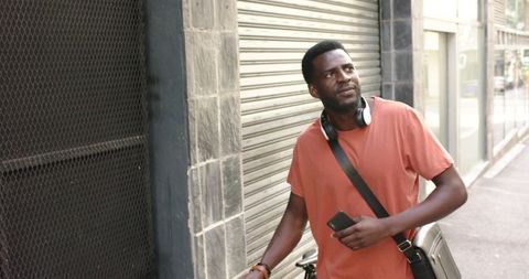 Urban Lifestyle: Young Man Holding Smartphone on New York Street