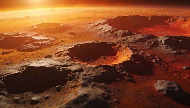 Martian crater field at sunset with rugged red terrain and dramatic orange horizon