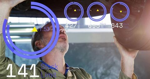 Mechanic inspecting vehicle undercarriage with augmented reality diagnostic overlays