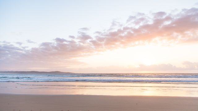 Serene Sunrise Over Gentle Waves on Calm Beach - Download Free Stock Photos Pikwizard.com