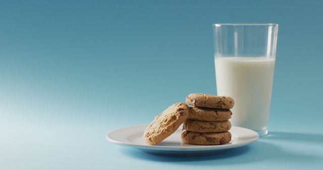 Image of biscuits with chocolate and milk on blue background. cookies,bake, food, candy, snacks and sweets concept.
