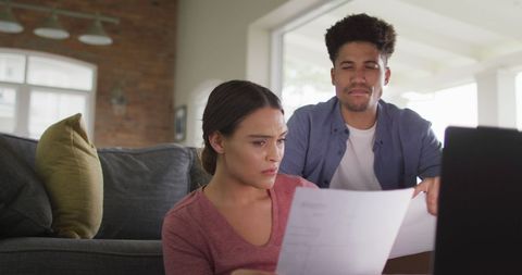 Biracial Couple Analyzing Documents on Sofa - Download Free Stock Images Pikwizard.com
