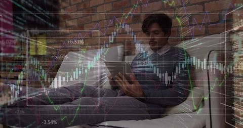 Young professional analyzing financial market data on tablet