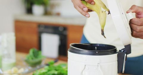 Man Preparing Healthy Green Smoothie in Modern Kitchen