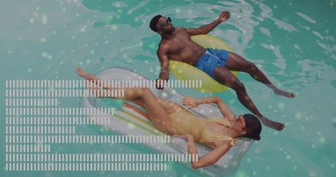 Relaxed Couple Floating on Pool Inflatable in Resort
