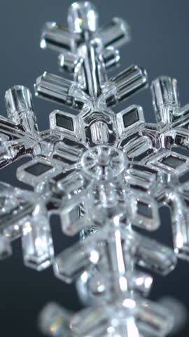 Opening Lens Revealing Macro Snowflake Crystal Facets and Light Refraction Vertical Video