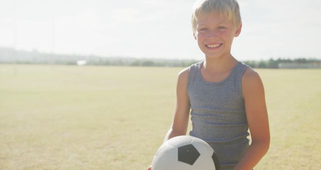 Young Boy Holding Soccer Ball on Sunny Day in Open Field - Download Free Stock Images Pikwizard.com