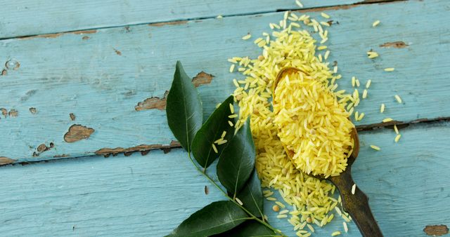 Yellow Rice Spilling from Spoon on Rustic Blue Wooden Table - Download Free Stock Images Pikwizard.com