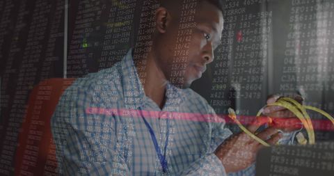 Data specialist managing server cables in high-tech environment