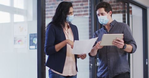 Diverse Coworkers Discussing at Office While Wearing Face Masks