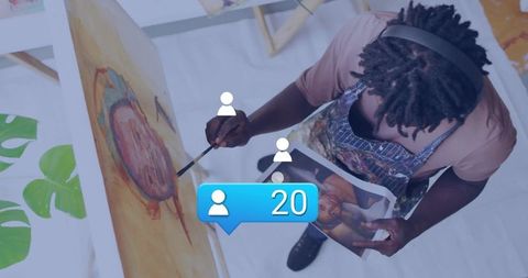 Artist in Studio Creating Painting with Digital Reference