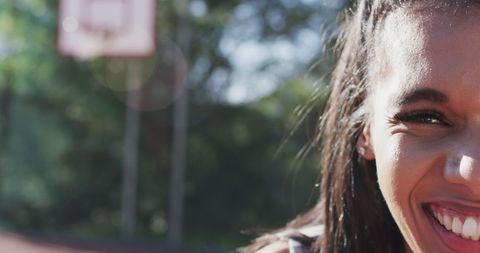 Close-up of Smiling Woman in Sunny Park