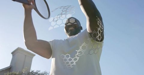 Serving tennis player wearing mirrored shades, swinging racket with hexagon hud overlay