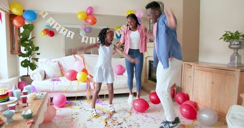 Family Celebrates Birthday with Dancing and Confetti in Bright Living Room