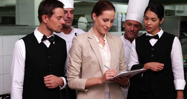 Restaurant Manager and Staff Discussing Plans in Professional Kitchen - Download Free Stock Images Pikwizard.com