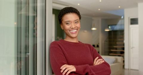 Woman in cozy attire relaxing at home in modern apartment