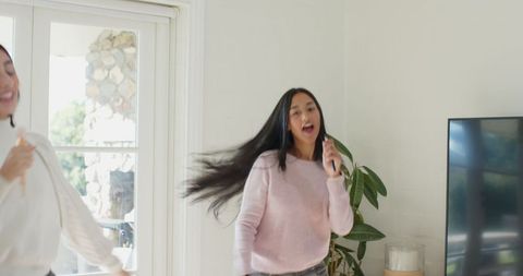 Diverse Friends Singing and Dancing at Home Enjoying Leisure Time