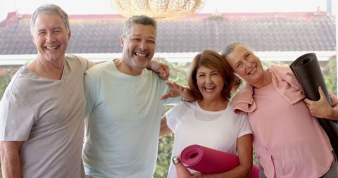 Diverse Friends Celebrating Wellness with Yoga Mats