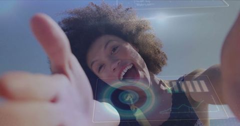 Joyful Woman Giving Thumbs Up with Futuristic Holographic Elements