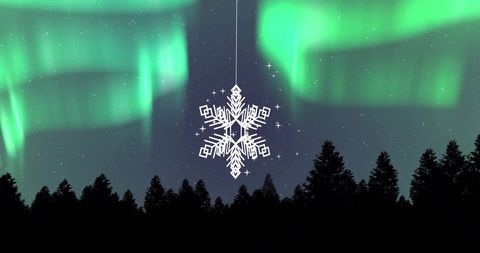 Enchanting snowflake ornament against northern lights