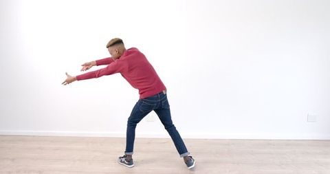 Energetic Young Man Dancing in Minimalist Room