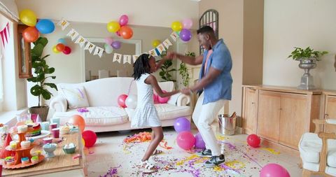 Family Celebrates Daughter's Birthday, Enjoying Party Cleanup Fun