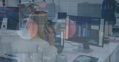 Businesswoman Analyzing Financial Data on Multiple Screens