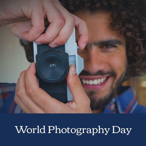 smiling man enjoying world photography day with camera - Download Free Stock Templates Pikwizard.com