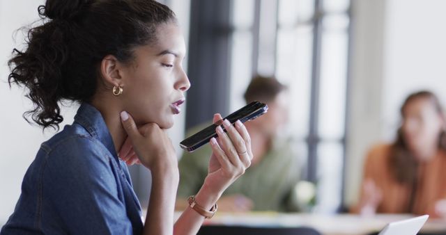 Businesswoman Using Voice Command on Smartphone in Office - Download Free Stock Images Pikwizard.com