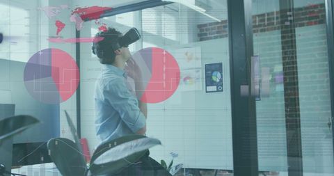 Businessman Analyzing Virtual Financial Data with VR Headset in Modern Office