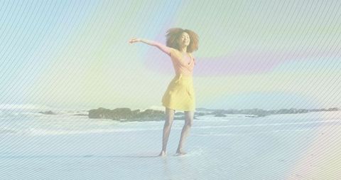 Joyful woman in yellow dress relaxing by ocean on sandy beach