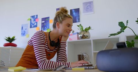 Creative female professional working at modern desk in office space