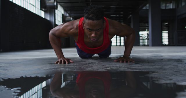 Determined Man Performing Push-Ups in Dark Warehouse - Download Free Stock Images Pikwizard.com