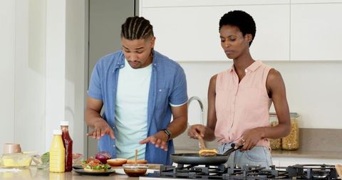 Diverse Couple Cooking Burgers in Modern Kitchen