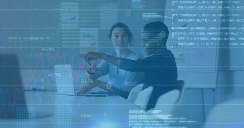 Businesswomen Pointing at Laptop Discussing Financial Analytics with Data Overlay
